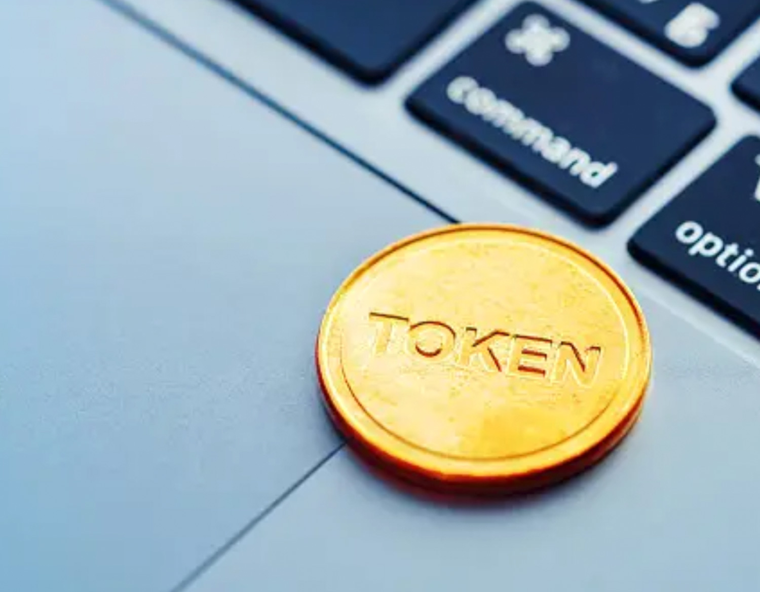close view of a gold "token" an a laptop keyboard