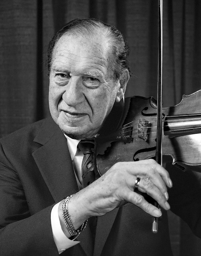 black and white photo of man wearing suit playing violin