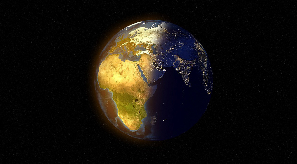 view of earth from space with sun shining on left side