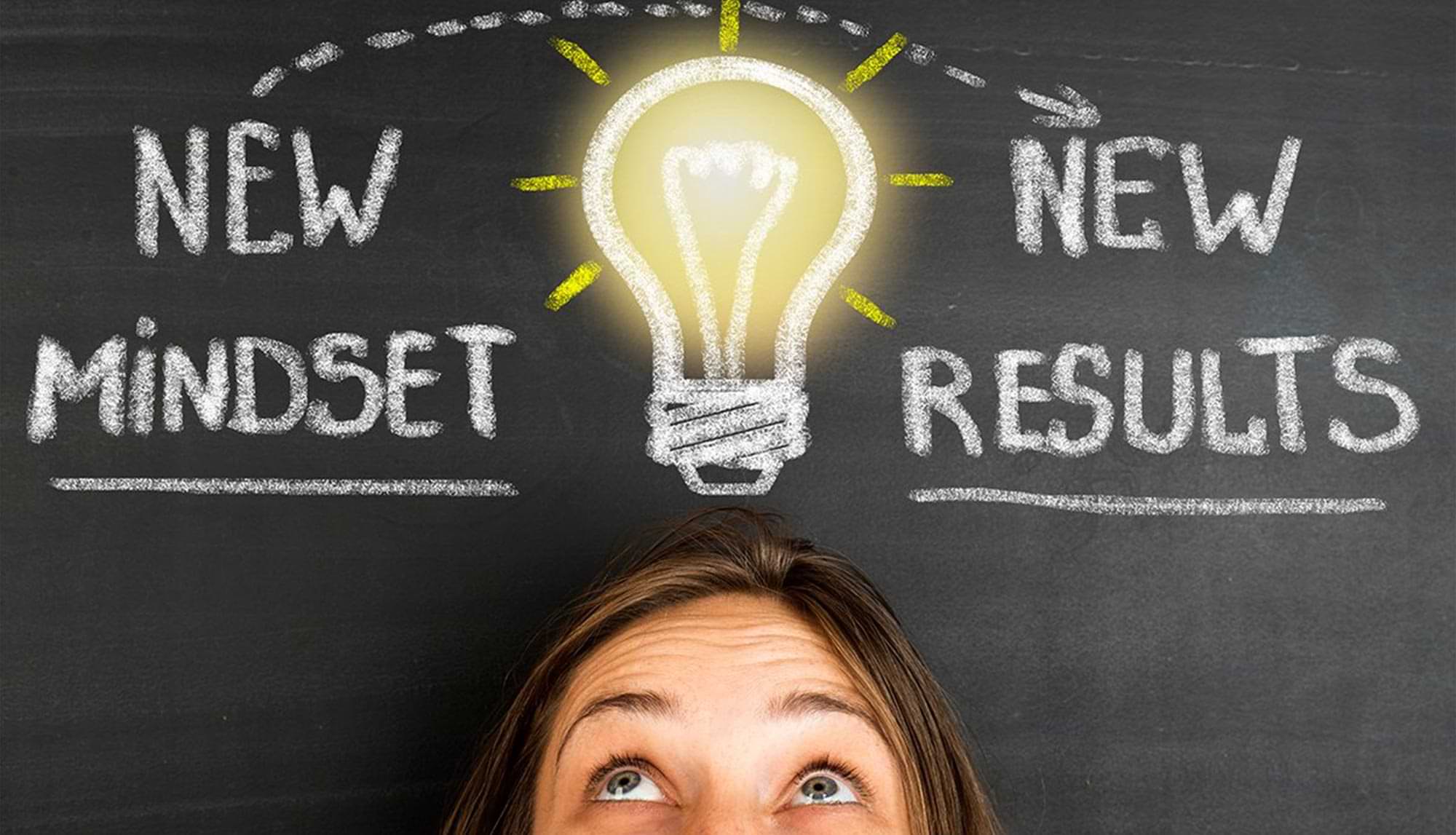 close view of the upper half of a woman's face, above her head shines a bright lightbulb, to the left of the lightbulb reads: NEW MINDSET and to the right reads: NEW RESULTS 