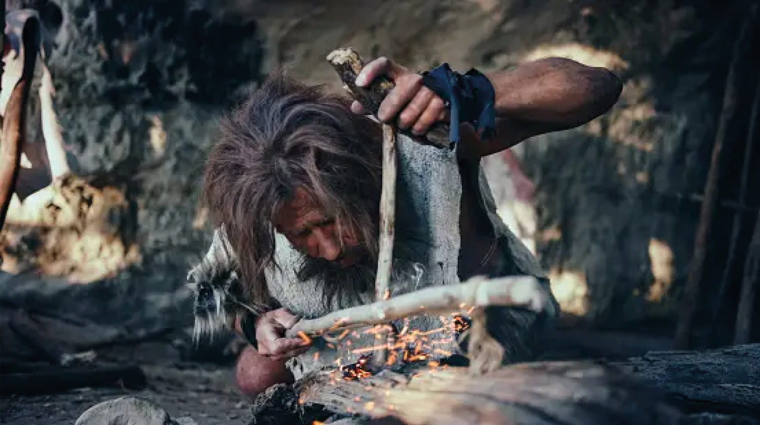 caveman creating fire with two sticks